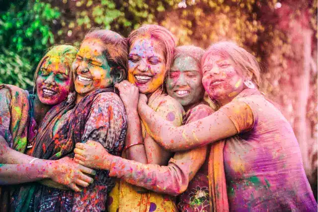 Vibrant Holi celebration with a loving family, showcasing joyous splashes of color. Discover skin-friendly Holi makeup tips for a radiant glow and hair care tricks to safeguard against color damage. Embrace the festive spirit with easy-to-follow beauty hacks for a stunning and safe celebration